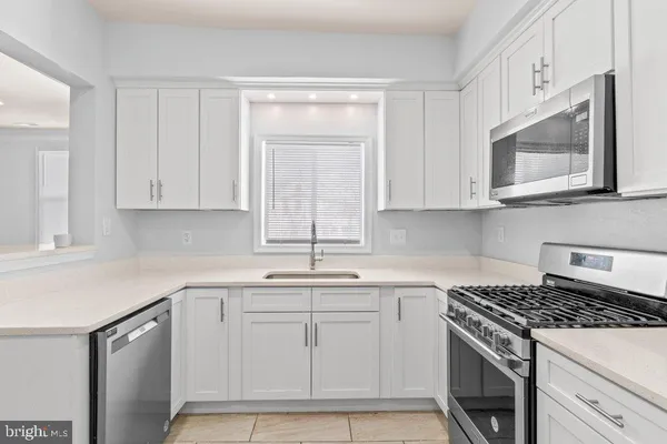 a room with a washing machine and mirrors