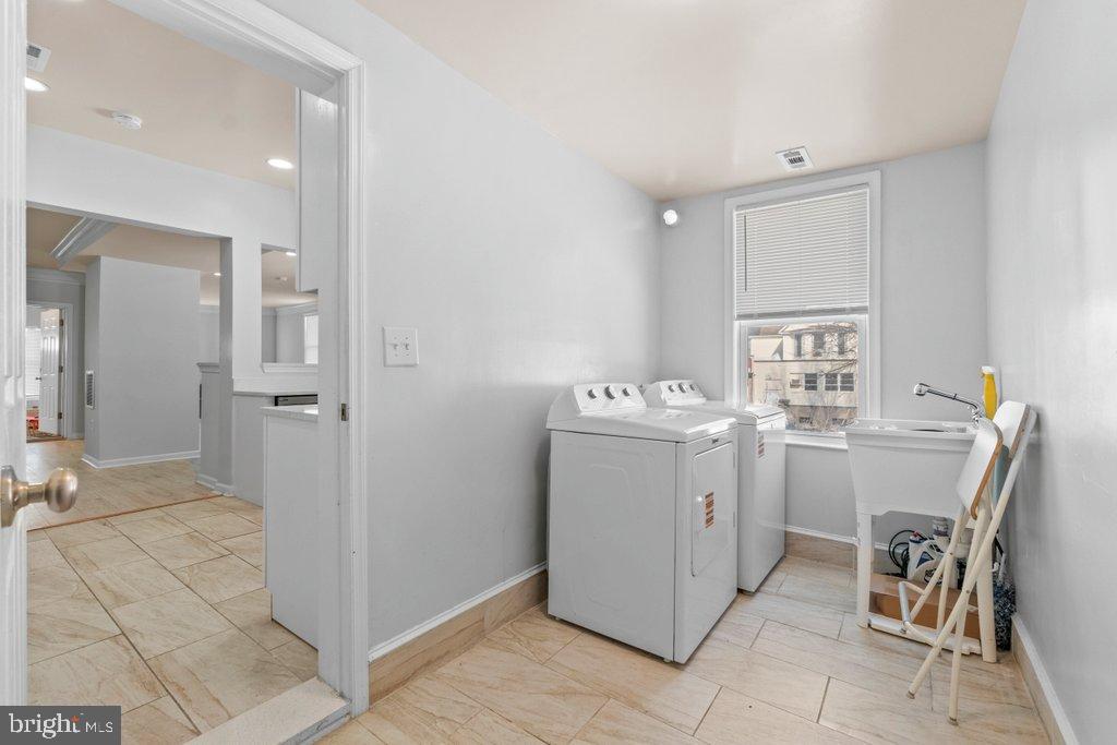 4919 Harford Road Baltimore, MD 21214 - Photo 18 of 48 a room with a washing machine and mirrors