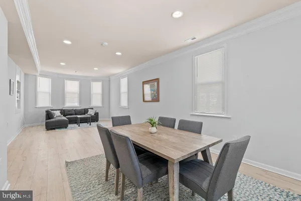 a living room with furniture and a dining table with kitchen view