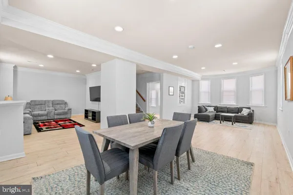 a view of a dining room with furniture and wooden floor
