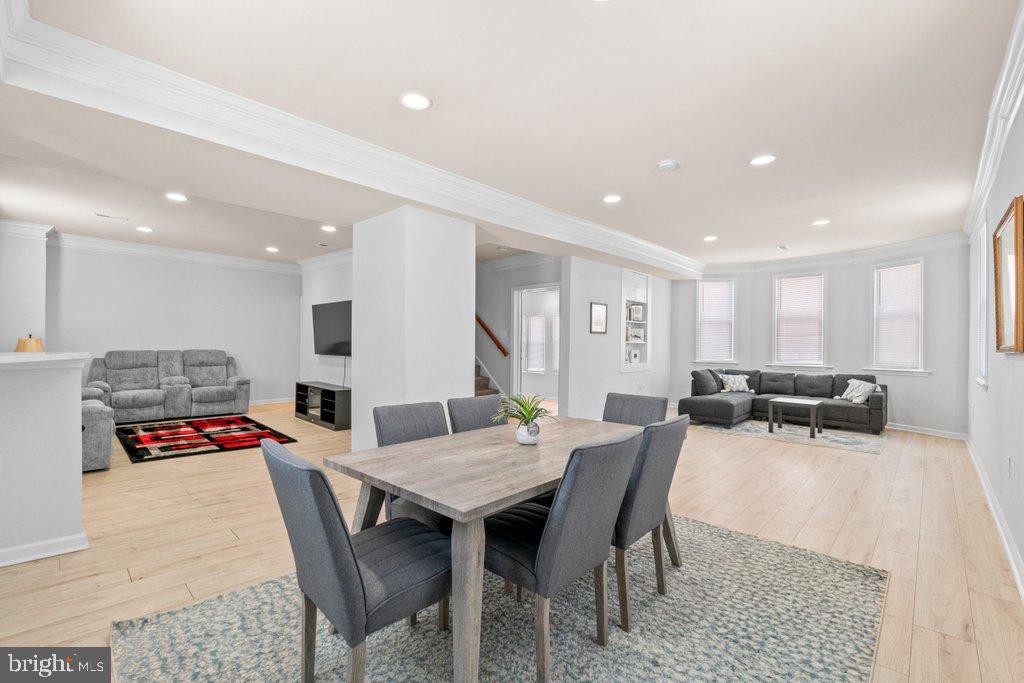 4919 Harford Road Baltimore, MD 21214 - Photo 21 of 48 a living room with furniture and a dining table with kitchen view