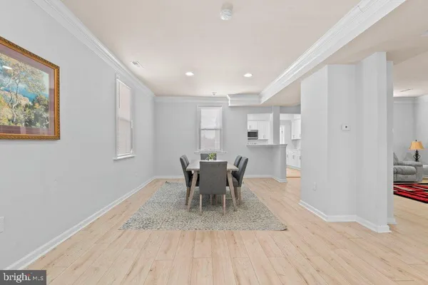 a living room with furniture windows and a wooden floor