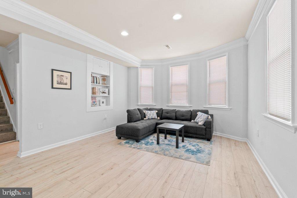 4919 Harford Road Baltimore, MD 21214 - Photo 23 of 48 a living room with furniture windows and a wooden floor