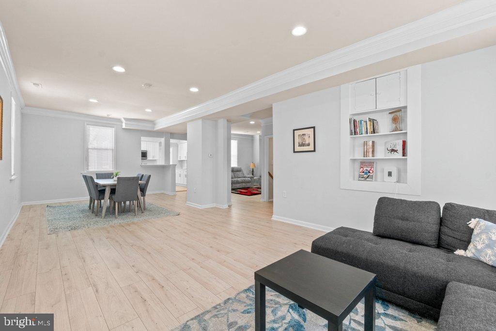 4919 Harford Road Baltimore, MD 21214 - Photo 24 of 48 a living room with furniture and a dining table with wooden floor