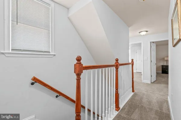 a bedroom with a bed and a window with dresser