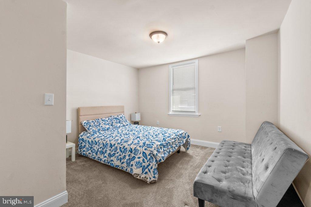 4919 Harford Road Baltimore, MD 21214 - Photo 26 of 48 a bedroom with a bed and a window with dresser