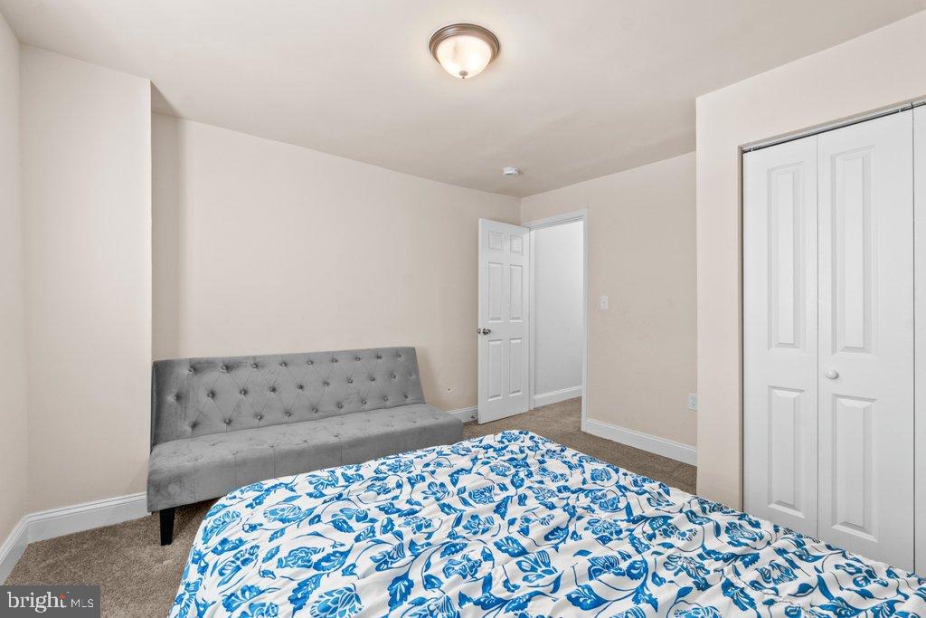 4919 Harford Road Baltimore, MD 21214 - Photo 27 of 48 a bedroom with a bed and a window