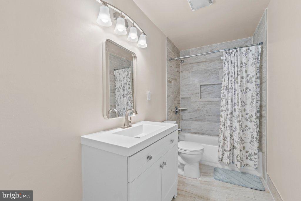 4919 Harford Road Baltimore, MD 21214 - Photo 28 of 48 a bathroom with a sink a toilet and shower