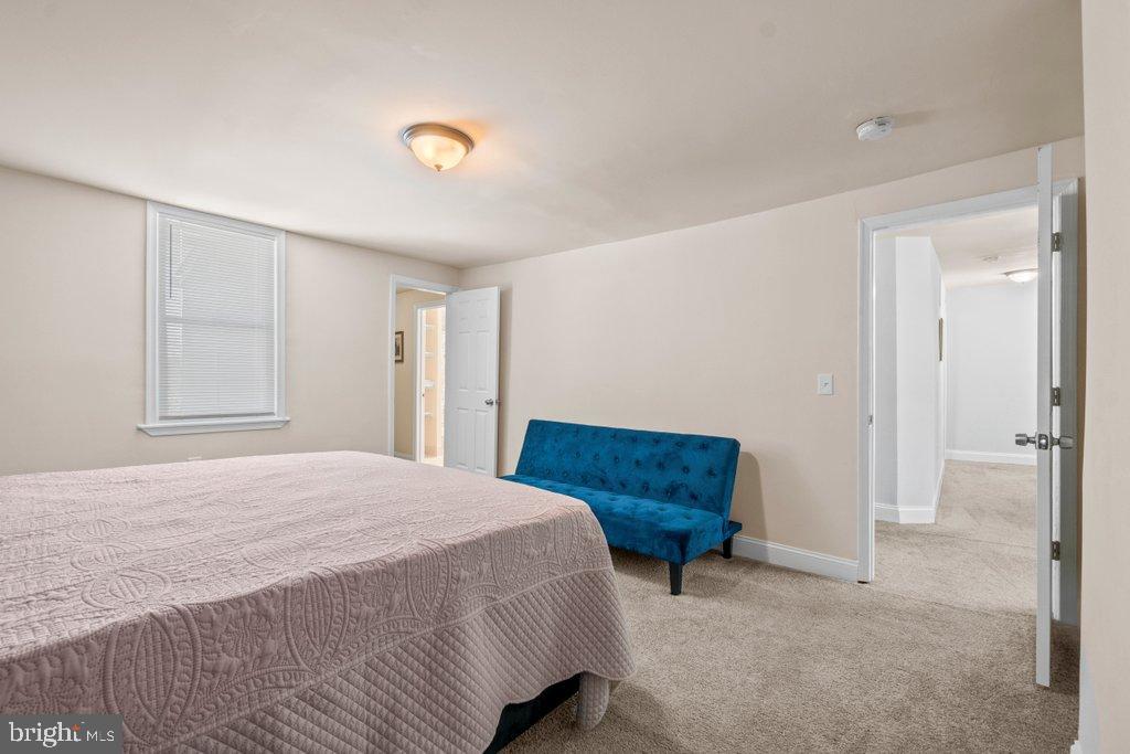4919 Harford Road Baltimore, MD 21214 - Photo 30 of 48 a bedroom with a bed and a window