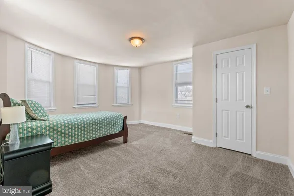 a room with a bed and chandelier