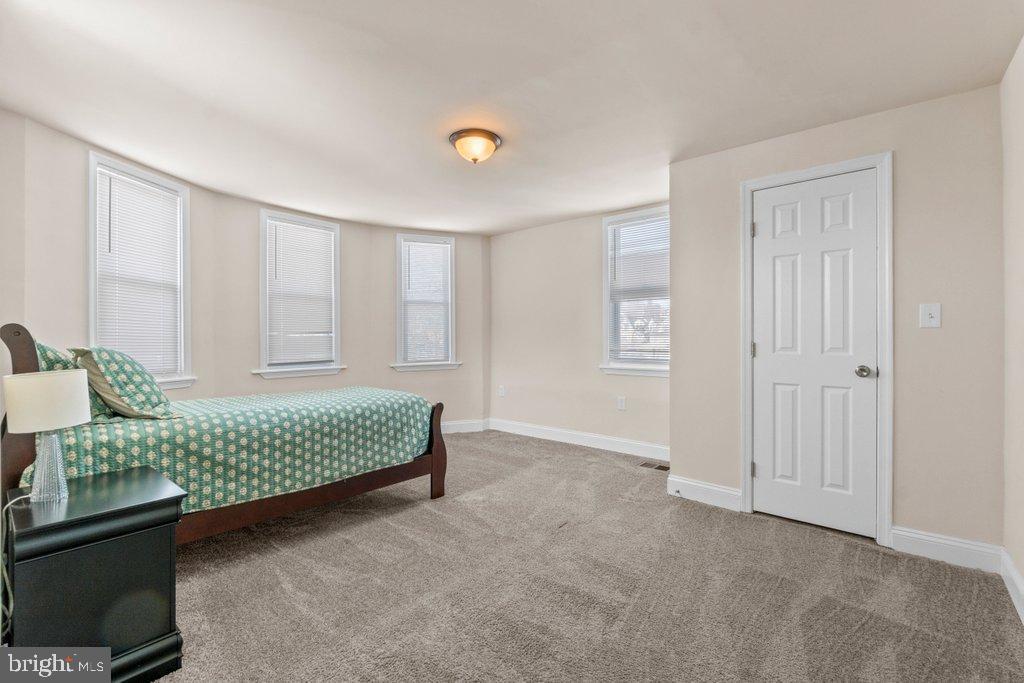 4919 Harford Road Baltimore, MD 21214 - Photo 35 of 48 a bedroom with a bed and a dresser