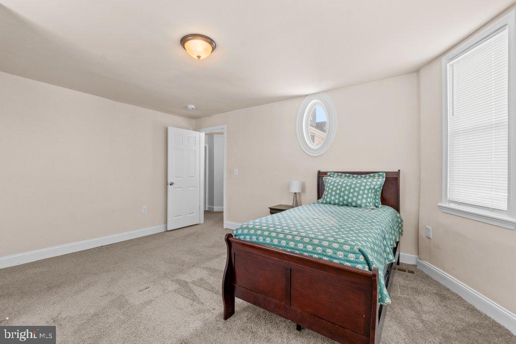 4919 Harford Road Baltimore, MD 21214 - Photo 36 of 48 a room with a bed and chandelier