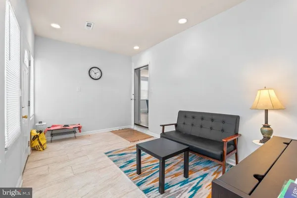 a living room with furniture and a lamp