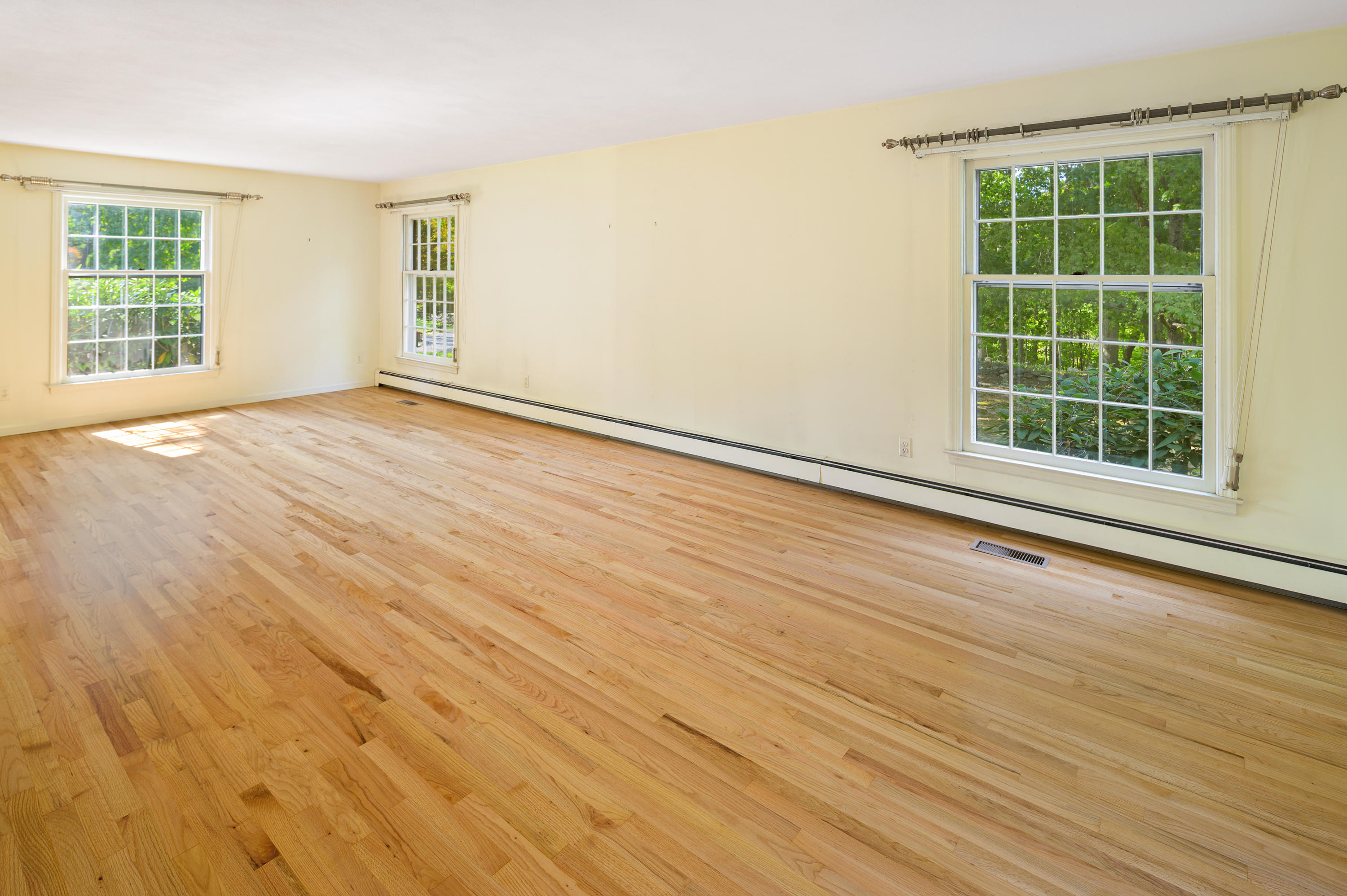 12 Lynam Road Stamford, CT 06903 - Photo 3 of 21 an empty room with wooden floor and windows