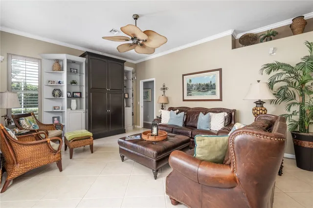 a living room with furniture ceiling fan and a rug