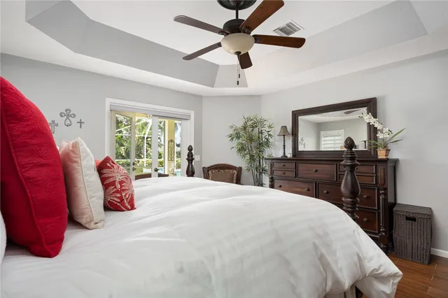 a bedroom with a bed and dresser with mirror
