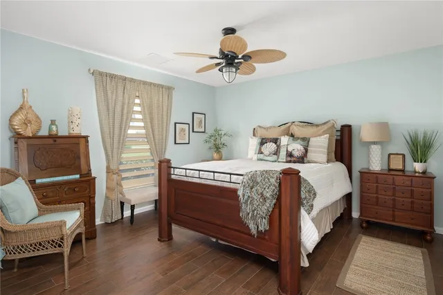 a bedroom with a bed a chair and a chandelier