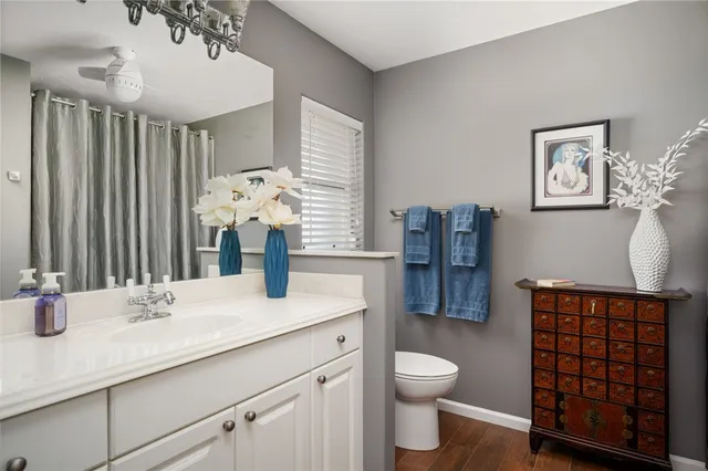 a bathroom with a sink a toilet and mirror