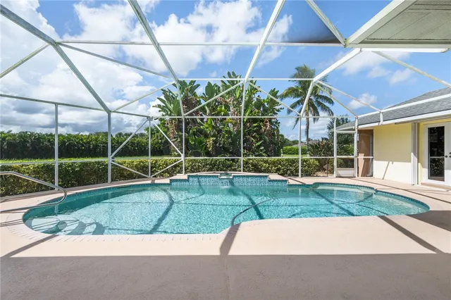 a view of a house with a backyard and a garden