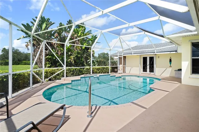 a view of a backyard with swimming pool