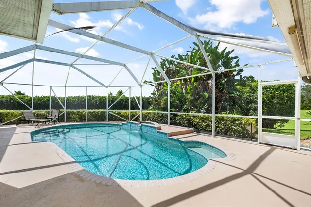 a view of a dining room with furniture wooden floor and chandelier