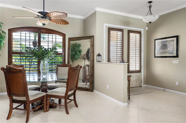 a dining room with furniture a chandelier and window