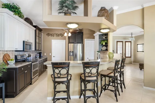 a view of a dining room with furniture and a chandelier