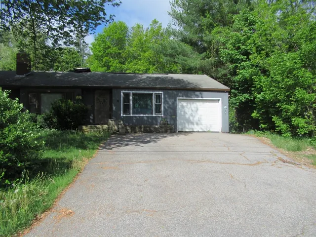a front view of a house with a yard and a garage