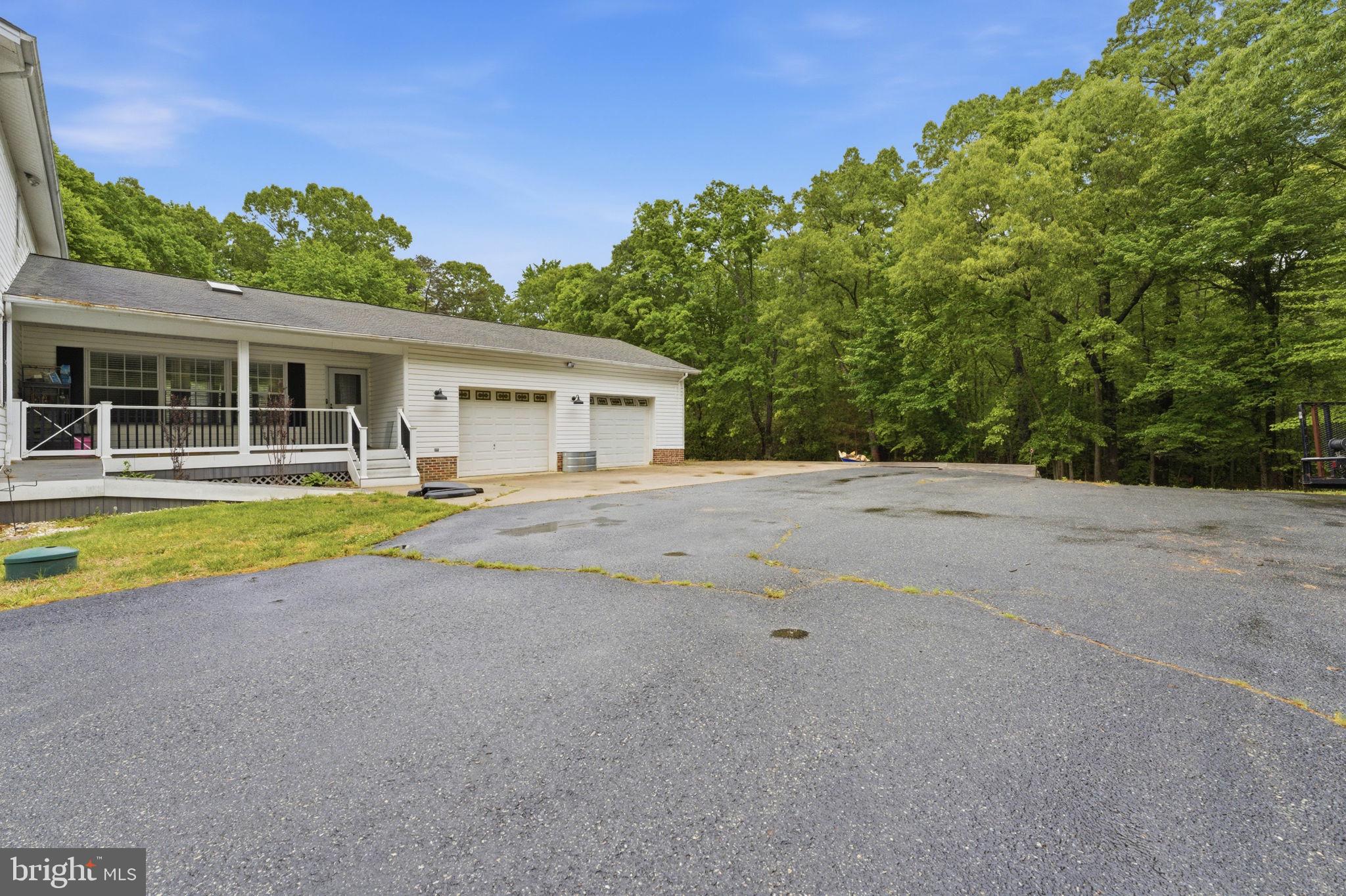6040 Southgate Farm Road Indian Head, MD 20640 - Photo 71 of 94 Spacious driveway amidst lush greenery.
