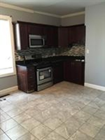 1 Proctor Street Haverhill, MA 01832 - Photo 3 of 6 a kitchen with stainless steel appliances granite countertop a stove a microwave and a sink