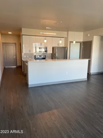 a view of kitchen with refrigerator and window