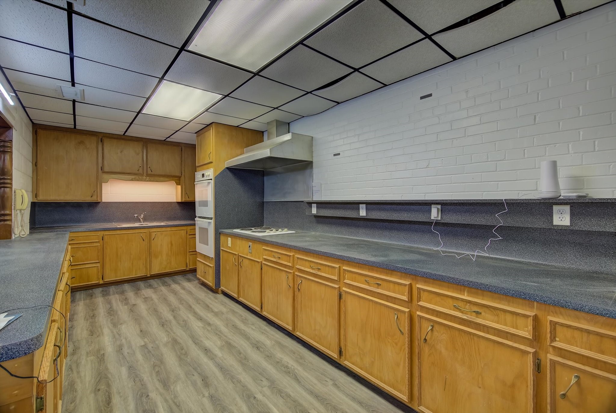 358 Demolay Street La Marque, TX 77568 - Photo 10 of 39 a large kitchen with stainless steel appliances wooden cabinets