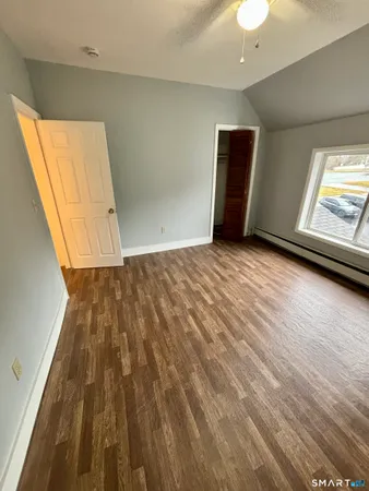 a view of a hallway with wooden floor