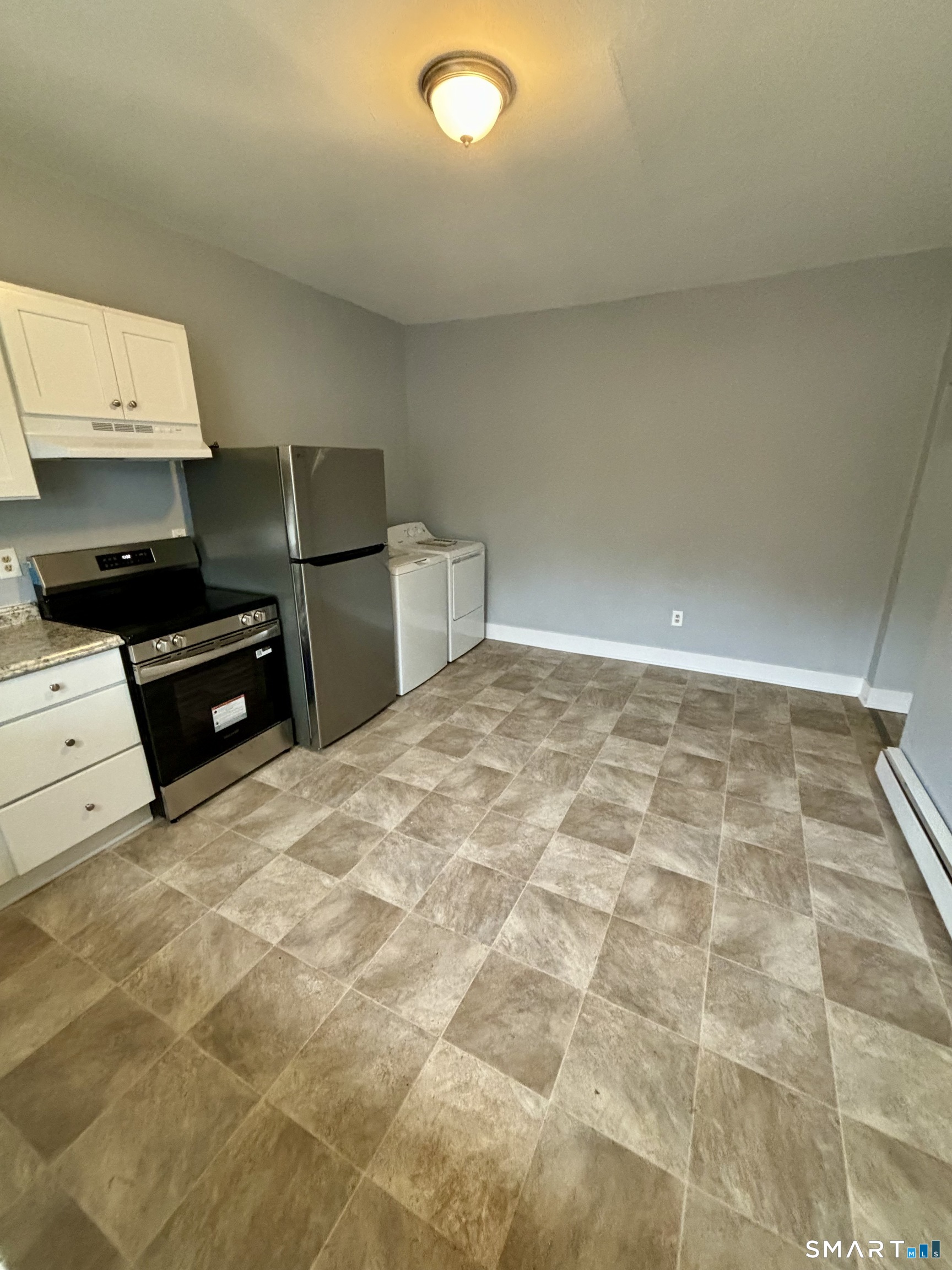 411 Main Street, Unit 1 Cromwell, CT 06416 - Photo 5 of 15 a kitchen that has a sink and a stove