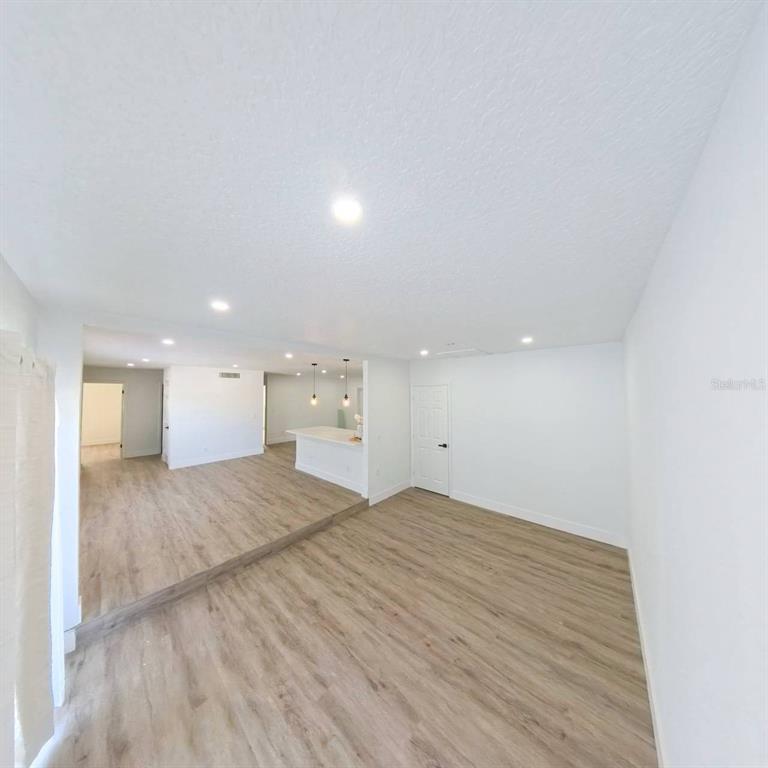 905 Spring Creek Drive Ocoee, FL 34761 - Photo 12 of 43 a view of empty room with wooden floor