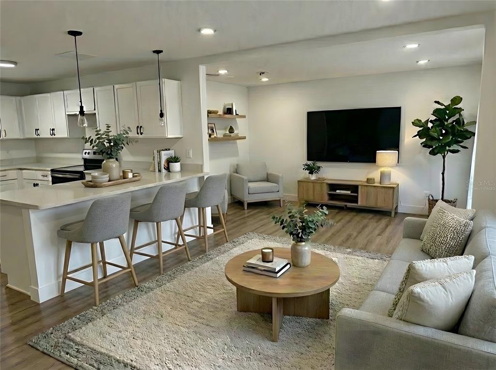 905 Spring Creek Drive Ocoee, FL 34761 - Photo 12 of 35 a living room with furniture a dining table and a potted plant