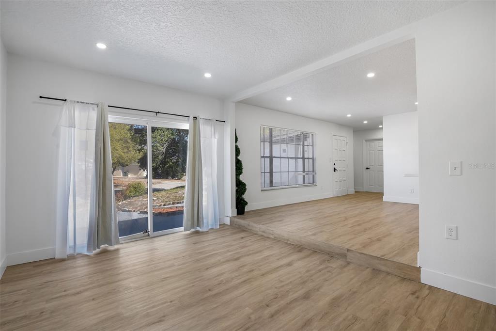 905 Spring Creek Drive Ocoee, FL 34761 - Photo 13 of 35 a view of empty room with wooden floor and fan