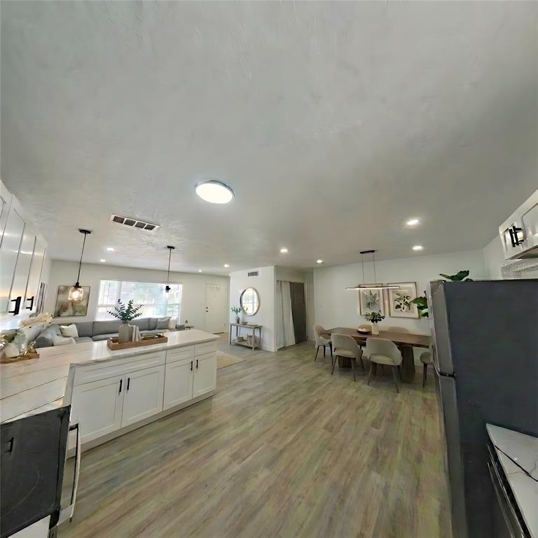 905 Spring Creek Drive Ocoee, FL 34761 - Photo 15 of 35 a kitchen with a sink dishwasher a stove and a refrigerator with wooden floor