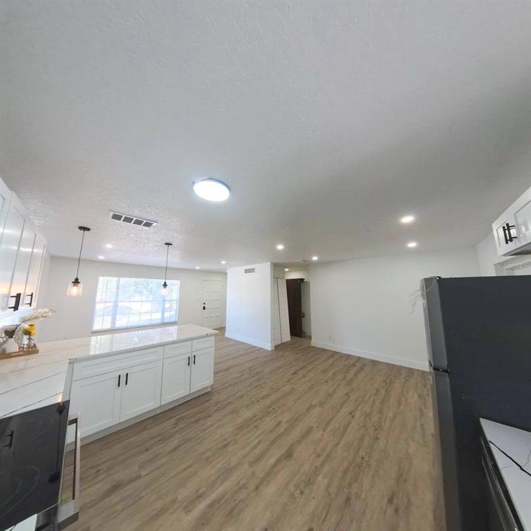 905 Spring Creek Drive Ocoee, FL 34761 - Photo 17 of 43 a view of a kitchen with a sink and a refrigerator
