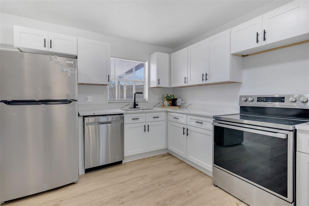 905 Spring Creek Drive Ocoee, FL 34761 - Photo 17 of 35 a kitchen with cabinets appliances and a counter space