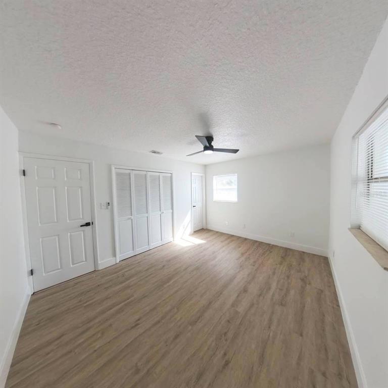 905 Spring Creek Drive Ocoee, FL 34761 - Photo 20 of 43 a view of empty room with wooden floor and fan