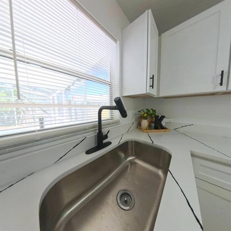 905 Spring Creek Drive Ocoee, FL 34761 - Photo 20 of 35 a kitchen with a sink and a window