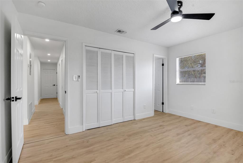 905 Spring Creek Drive Ocoee, FL 34761 - Photo 21 of 35 an empty room with wooden floor cabinet and windows