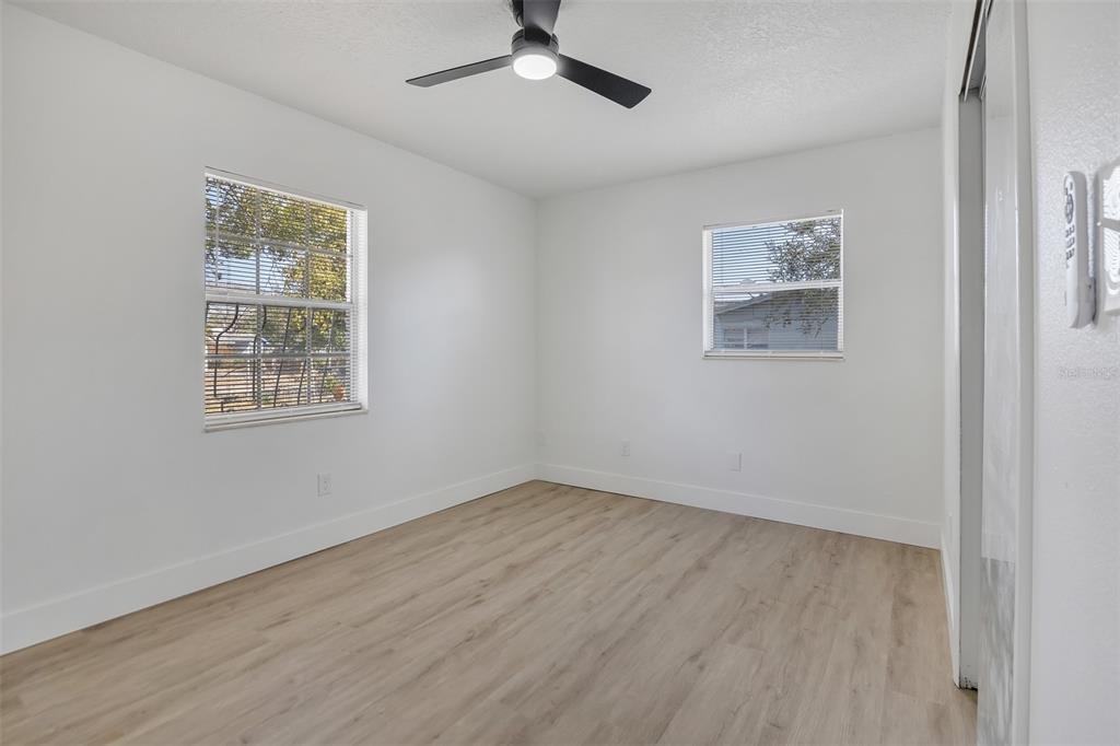 905 Spring Creek Drive Ocoee, FL 34761 - Photo 23 of 35 a view of an empty room with a window and wooden floor