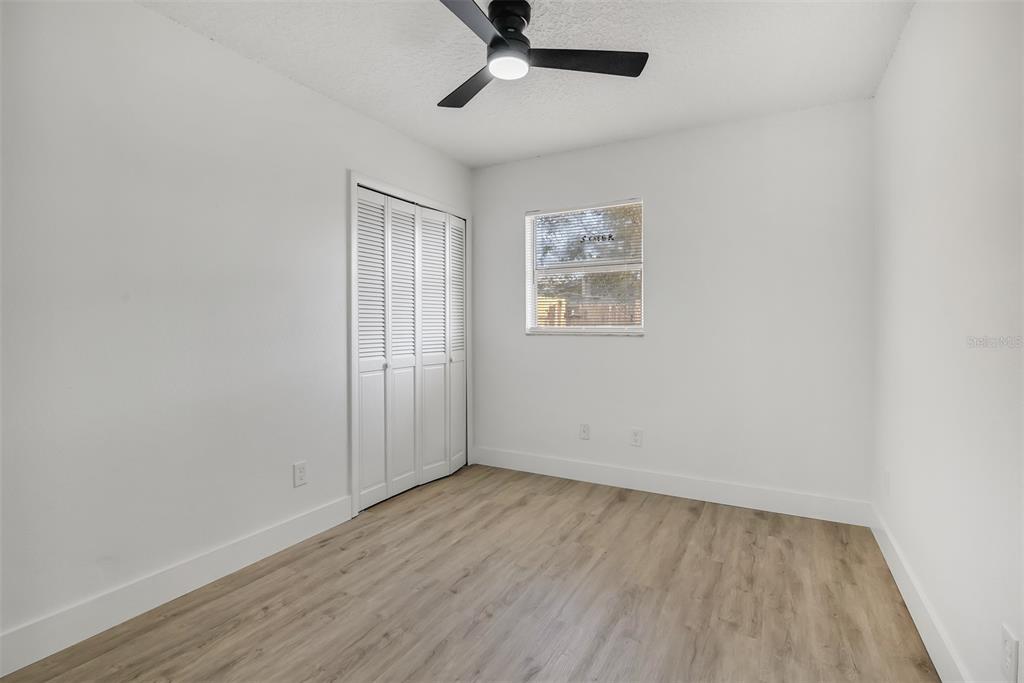 905 Spring Creek Drive Ocoee, FL 34761 - Photo 24 of 35 an empty room with a hardwood and ceiling fan