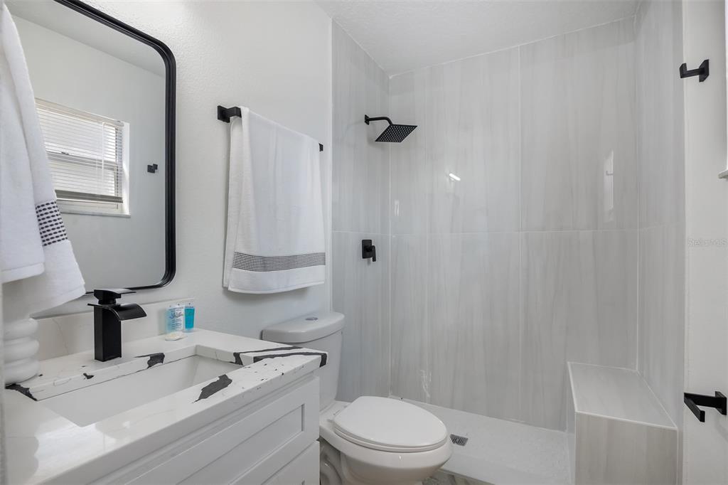 905 Spring Creek Drive Ocoee, FL 34761 - Photo 26 of 35 a bathroom with a sink a toilet and shower