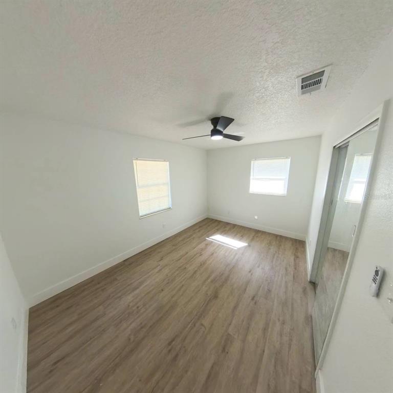 905 Spring Creek Drive Ocoee, FL 34761 - Photo 26 of 43 an empty room with wooden floor and windows