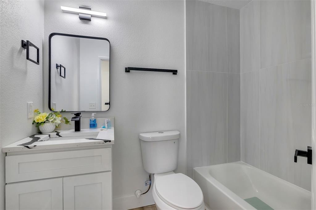 905 Spring Creek Drive Ocoee, FL 34761 - Photo 28 of 35 a bathroom with a toilet sink and mirror