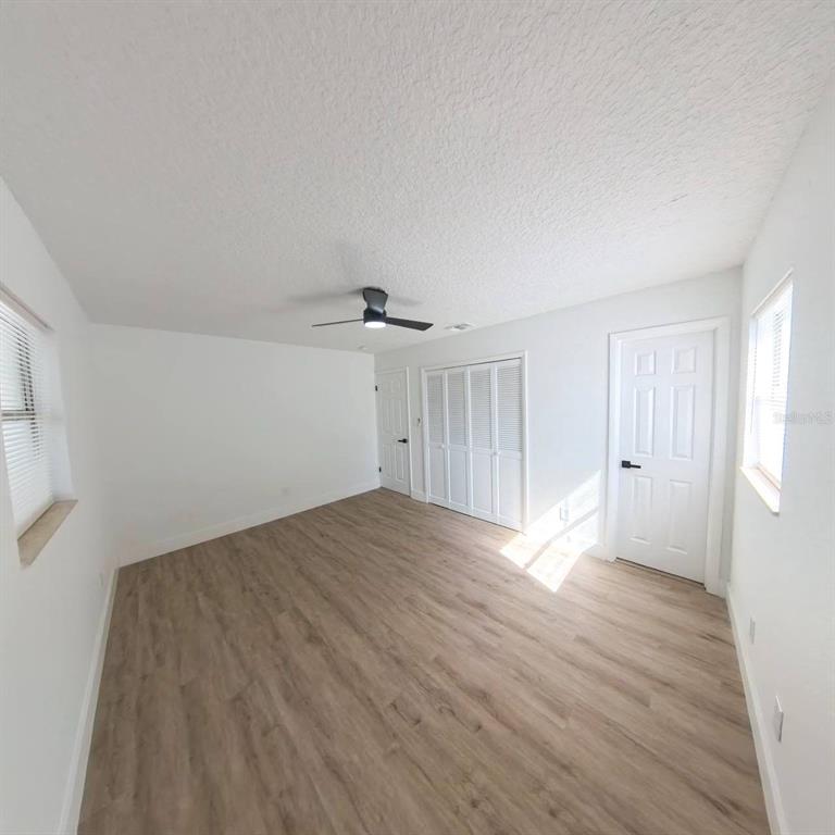 905 Spring Creek Drive Ocoee, FL 34761 - Photo 29 of 43 a view of empty room with wooden floor and fan