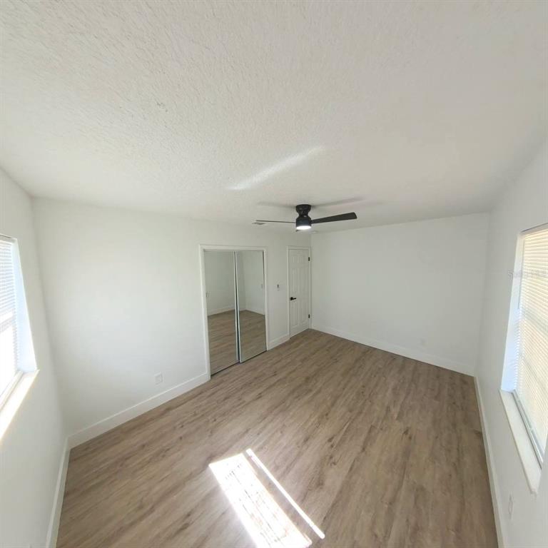 905 Spring Creek Drive Ocoee, FL 34761 - Photo 30 of 43 an empty room with wooden floor and windows